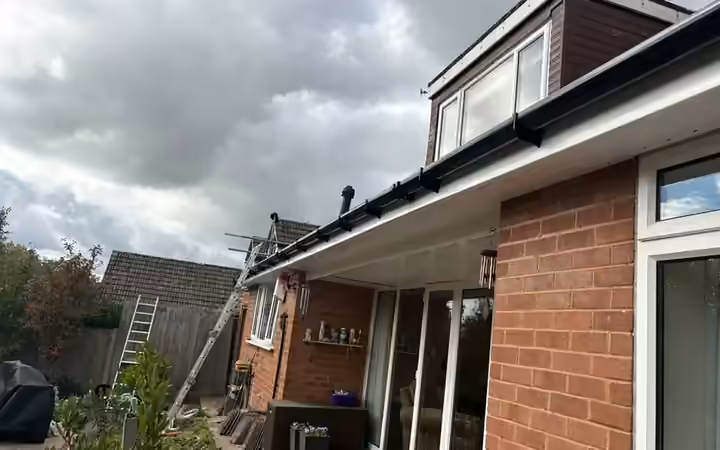 New white fascia and soffit boards with black guttering